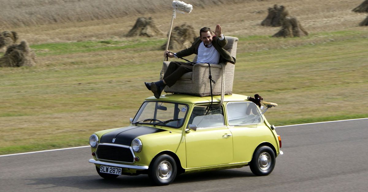 A guy riding in an easy chair on the roof of his driverless car